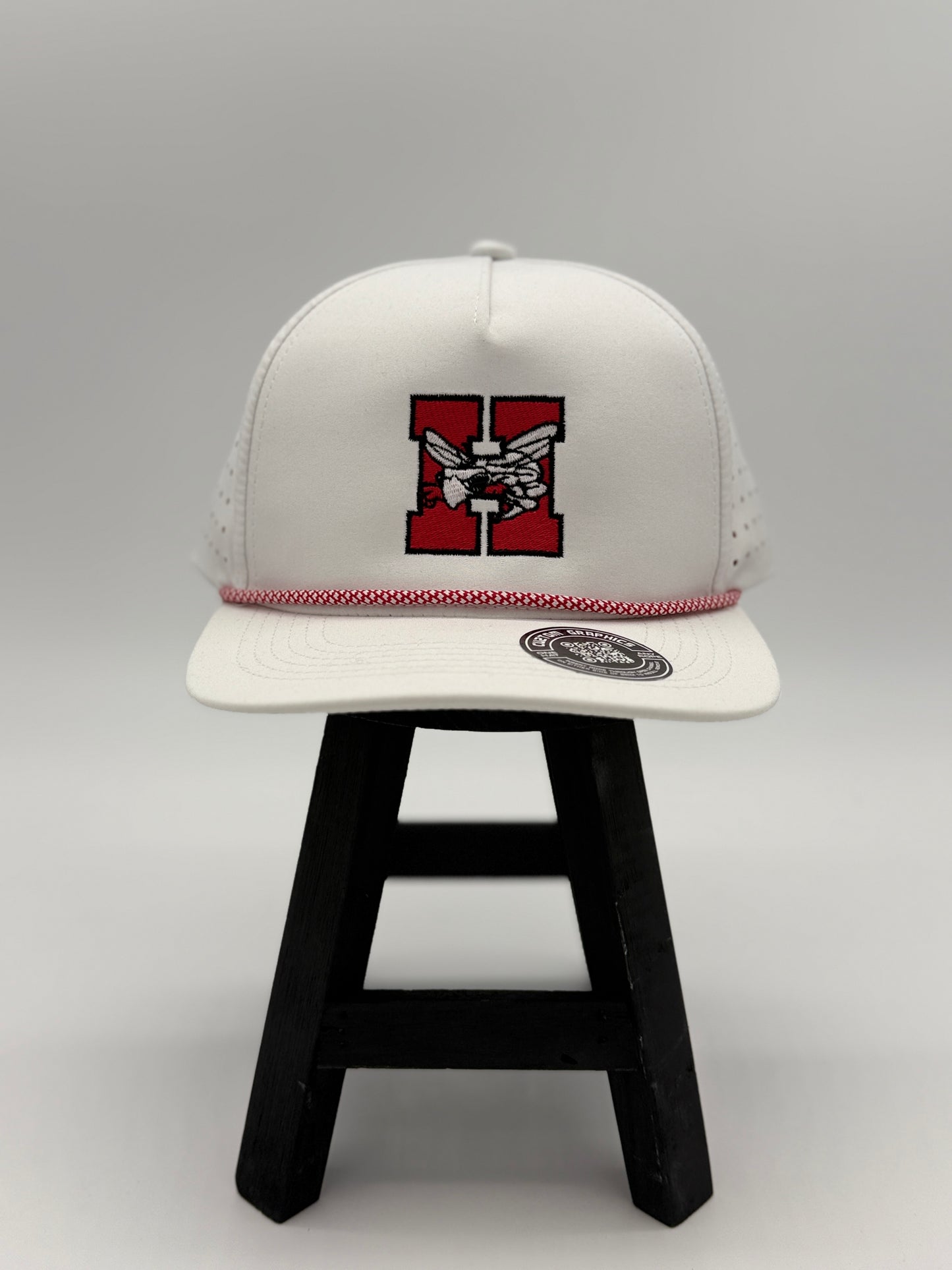 White Hilldale H embroidered cap with red and black logo and red stitched trim by Cuztom Graphics