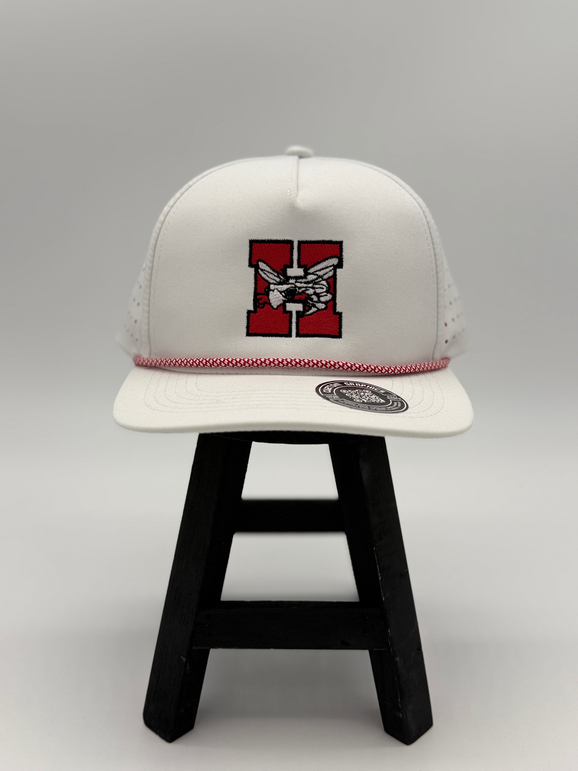 White Hilldale H embroidered cap with red and black logo and red stitched trim by Cuztom Graphics