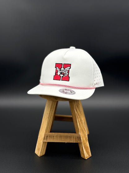 White Hilldale H embroidered cap with red and black design by Cuztom Graphics displayed on wooden stand