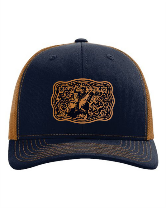 Custom western trucker cap by Cuztom Graphics with black front and brown mesh sides featuring a rodeo bull rider design